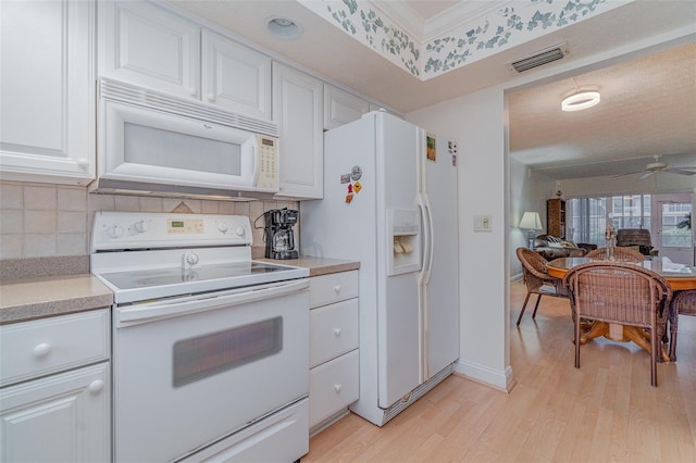 kitchen featuring tasteful backsplash, light hardwood / wood-style flooring, ceiling fan, white appliances, and white cabinets