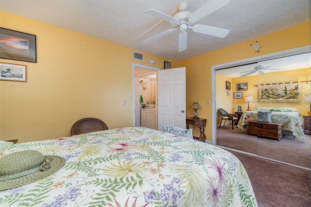 carpeted bedroom with ceiling fan, a closet, and a textured ceiling