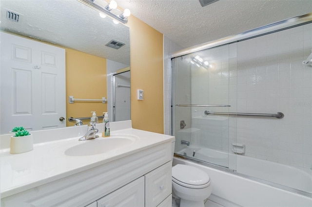 full bathroom featuring enclosed tub / shower combo, vanity, toilet, and a textured ceiling