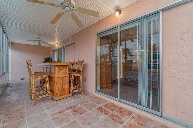 view of patio / terrace with exterior bar and ceiling fan