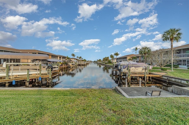 dock area with a yard and a water view