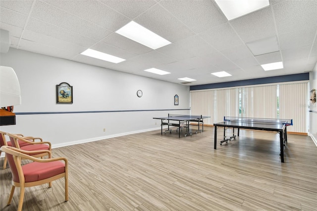 game room featuring hardwood / wood-style flooring and a paneled ceiling