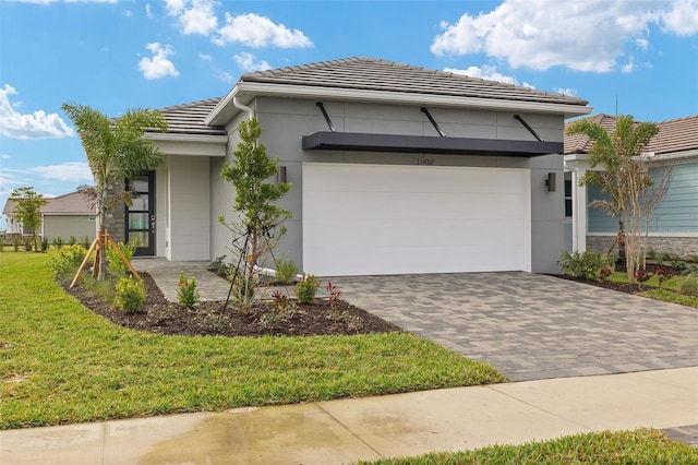 view of front of home featuring a garage and a front lawn