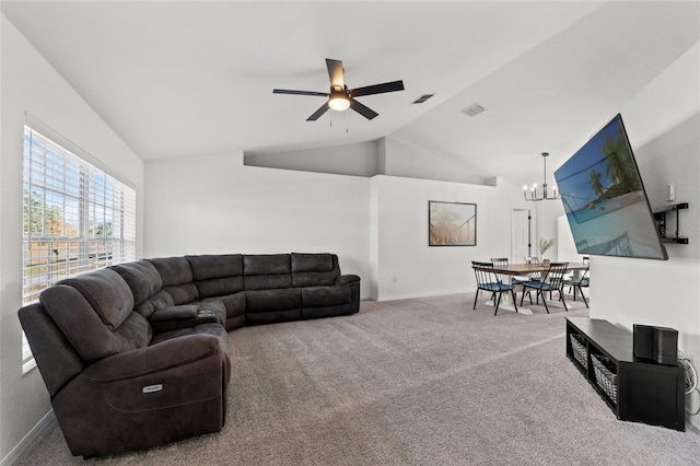 carpeted living room featuring lofted ceiling and ceiling fan with notable chandelier