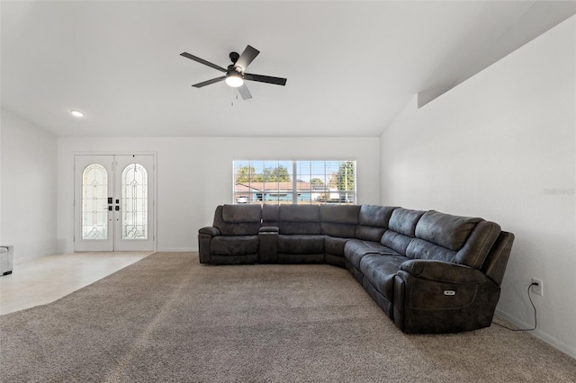 carpeted living room with ceiling fan, vaulted ceiling, french doors, and a healthy amount of sunlight