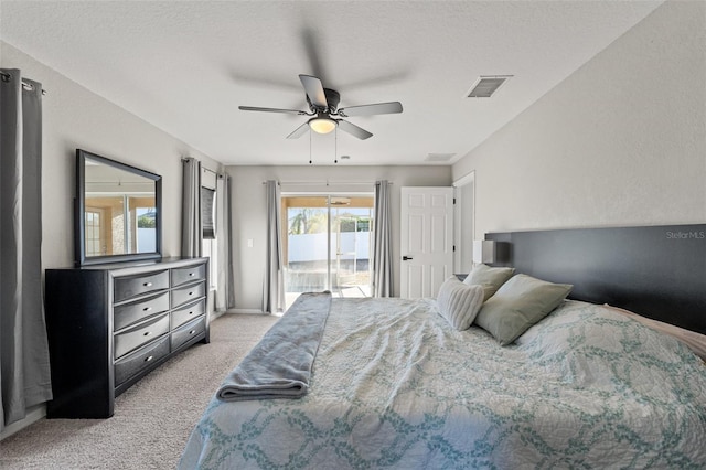 bedroom featuring light carpet, access to exterior, a textured ceiling, and ceiling fan