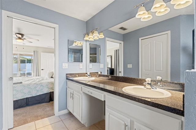 bathroom featuring ceiling fan, vanity, and tile patterned flooring