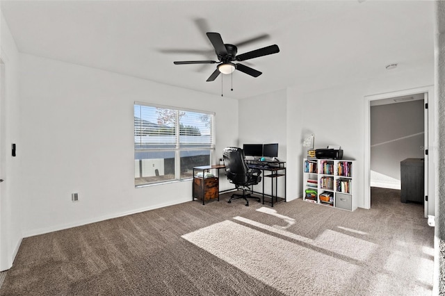 carpeted home office with ceiling fan