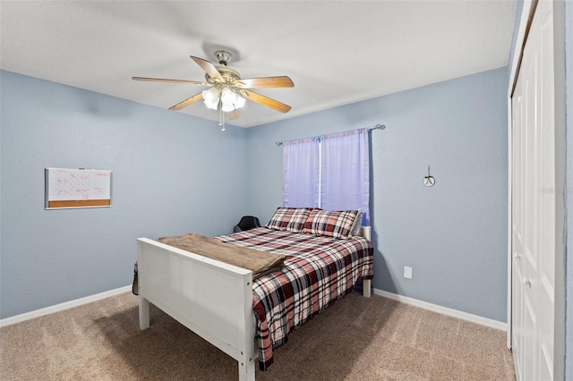 carpeted bedroom featuring a closet and ceiling fan