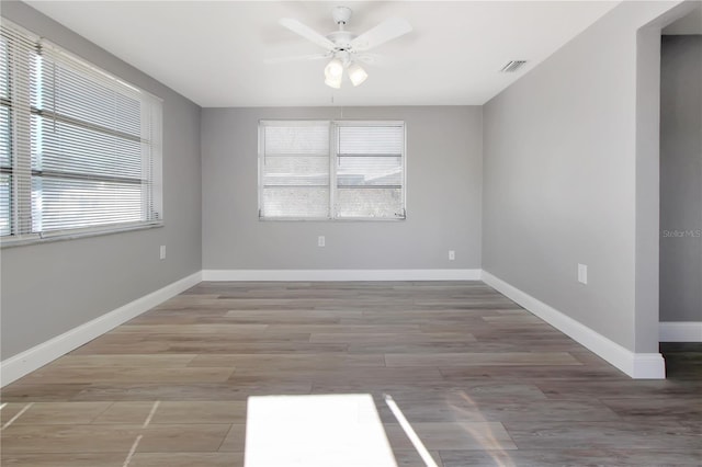 unfurnished room with hardwood / wood-style flooring and ceiling fan