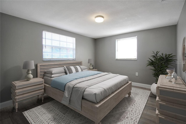 bedroom with dark hardwood / wood-style floors