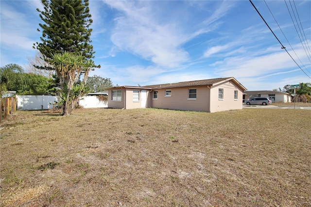 back of property featuring a lawn