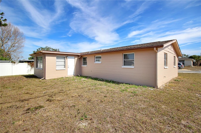 rear view of property with a lawn