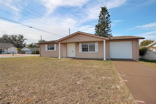 ranch-style home featuring a garage and a front lawn