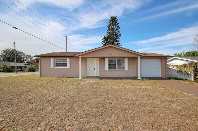 single story home featuring a garage and a front yard