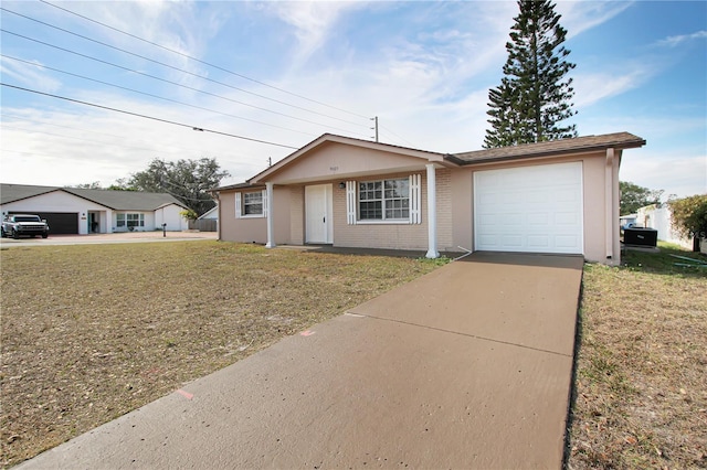 ranch-style house with a garage and a front lawn