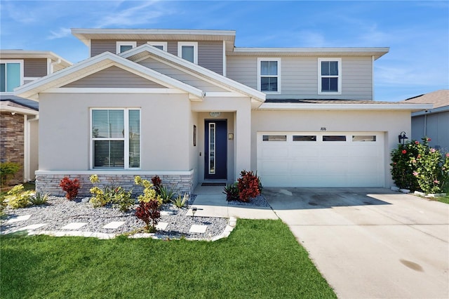 view of front of house with a garage and a front yard