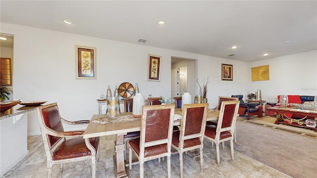 dining space with light colored carpet