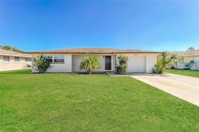 ranch-style house with a front lawn, a garage, and driveway