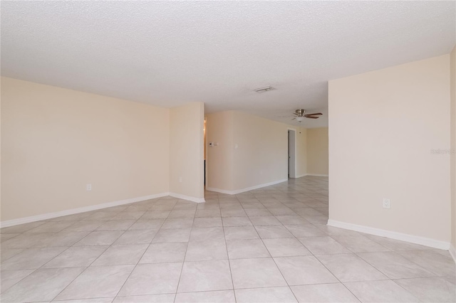 unfurnished room featuring baseboards, a textured ceiling, and ceiling fan