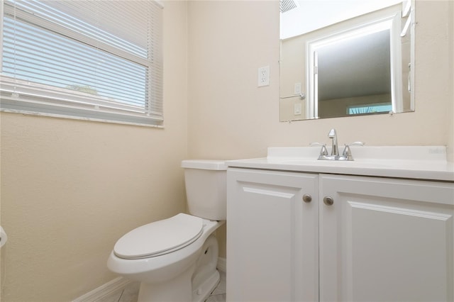 half bath featuring visible vents, toilet, vanity, and tile patterned flooring