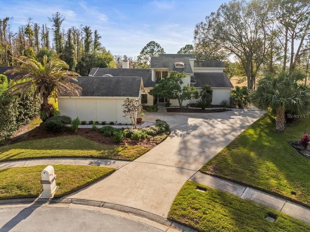 view of front of property with a garage and a front yard