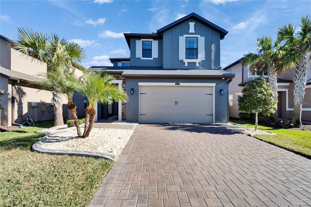 view of front property featuring a garage and a front lawn