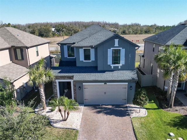 view of front of house featuring a garage and a front lawn