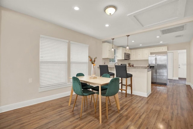 dining area with plenty of natural light and dark hardwood / wood-style floors