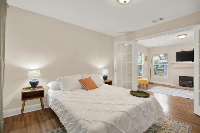 bedroom with dark wood-type flooring