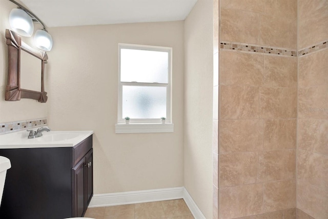 bathroom with vanity, tiled shower, and tile patterned floors