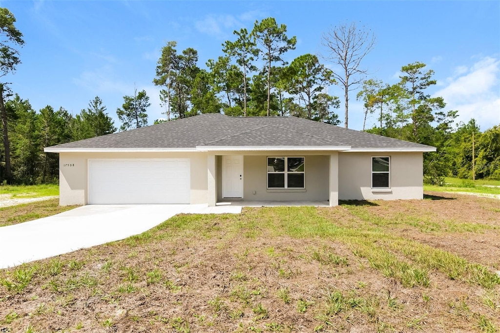 single story home with a garage and a front yard