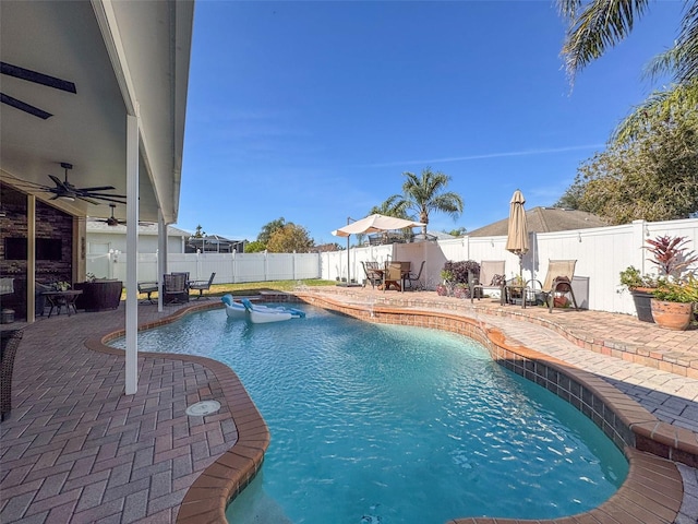 view of pool featuring ceiling fan and a patio area