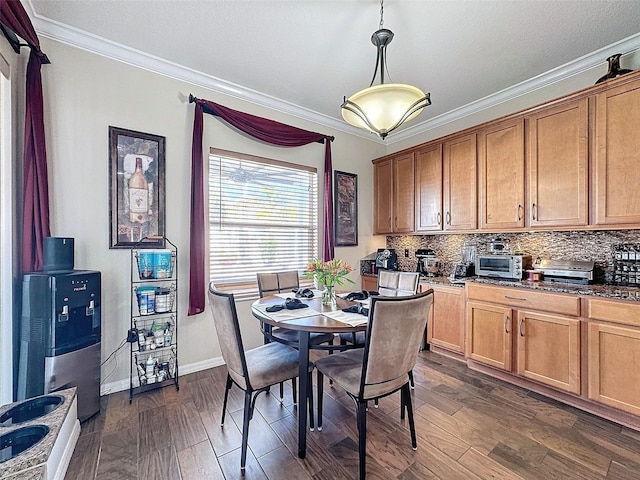 dining space with ornamental molding and dark hardwood / wood-style floors