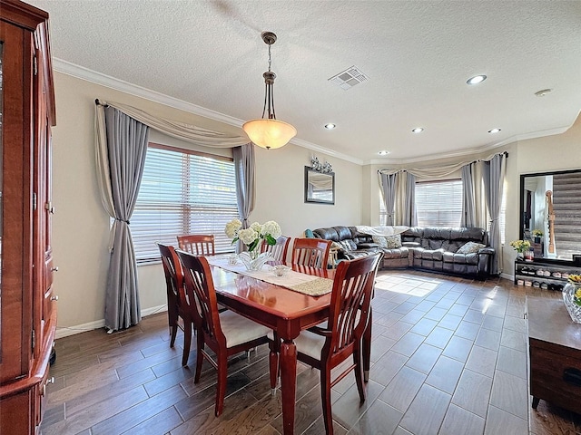 dining area featuring ornamental molding and a healthy amount of sunlight