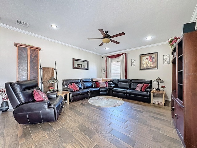 living room featuring ceiling fan, wood-type flooring, ornamental molding, and a textured ceiling