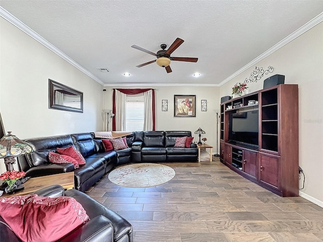 living room featuring ornamental molding, wood-type flooring, ceiling fan, and a textured ceiling