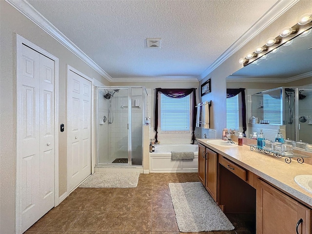 bathroom with tile patterned flooring, vanity, separate shower and tub, crown molding, and a textured ceiling