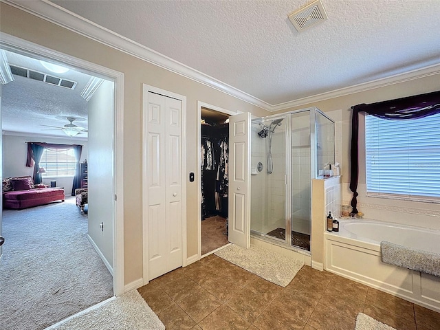 bathroom featuring crown molding, ceiling fan, tile patterned flooring, a textured ceiling, and shower with separate bathtub