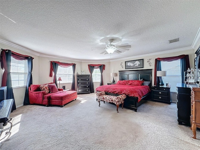 bedroom with crown molding, carpet floors, a textured ceiling, and ceiling fan