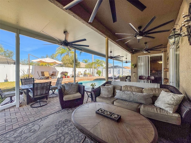 view of patio with a fenced in pool, an outdoor hangout area, and ceiling fan