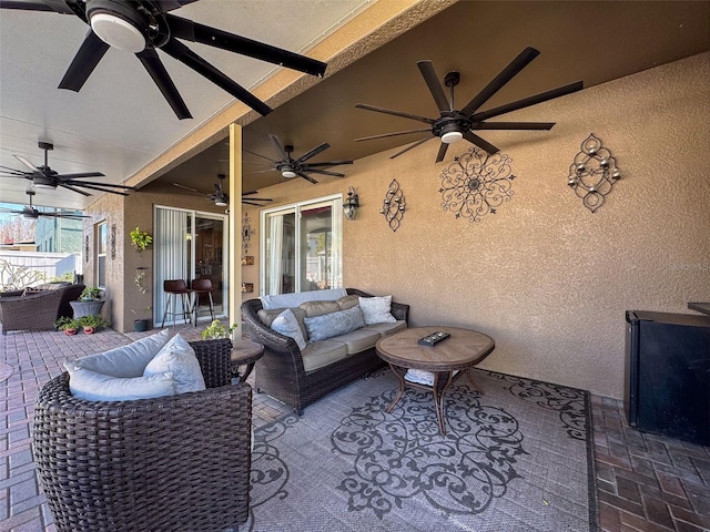 view of patio with an outdoor living space and ceiling fan