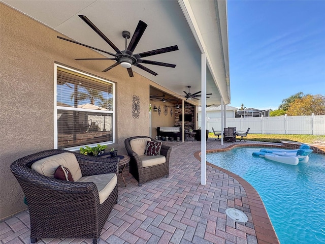 view of swimming pool with ceiling fan and a patio area