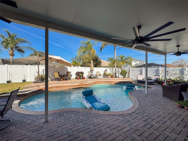 view of swimming pool featuring ceiling fan and a patio area