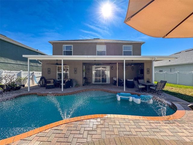 view of swimming pool featuring ceiling fan and a patio