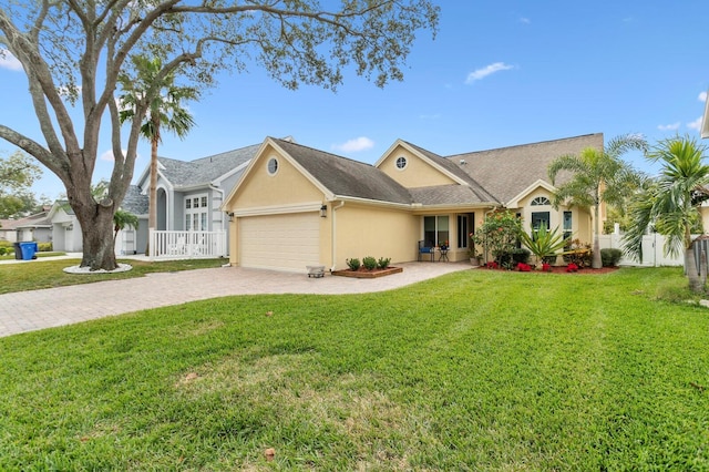 single story home with a garage and a front lawn