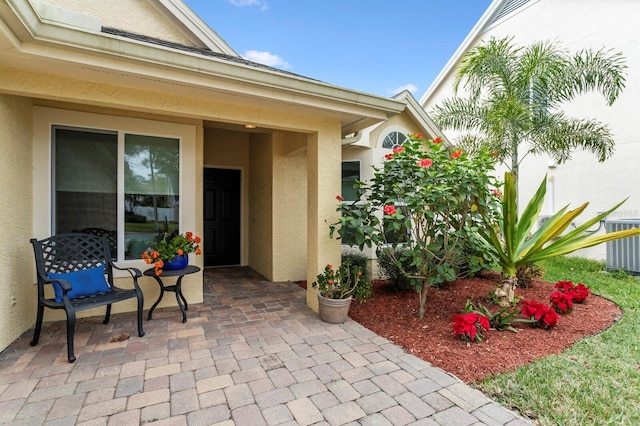 property entrance with a patio and central air condition unit