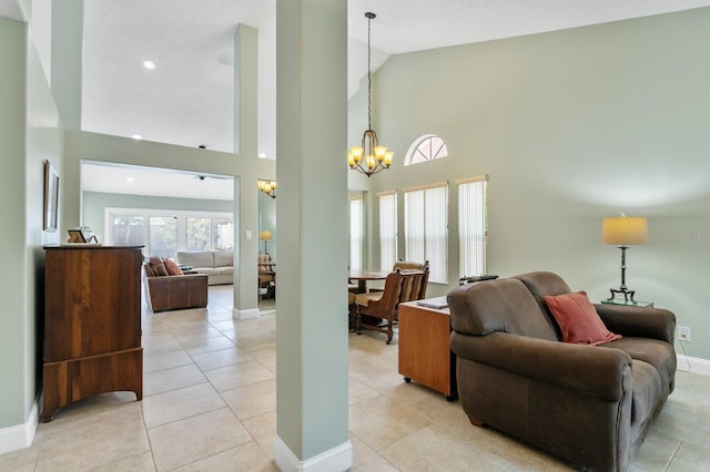 tiled living room with high vaulted ceiling and a chandelier