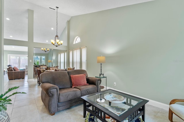 living room featuring a notable chandelier, light tile patterned floors, and high vaulted ceiling