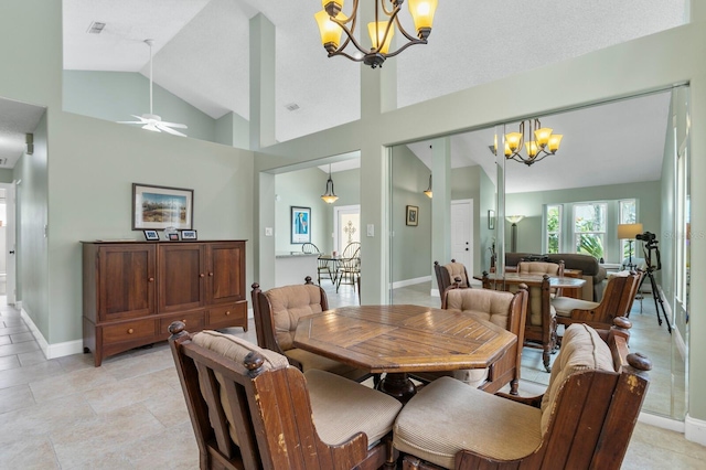 dining area featuring high vaulted ceiling and a chandelier